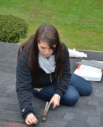 Annie Schakat of Springfield, Ohio, helps repair a roof during Repair Affair with her FIRST CLASS.  (CU Photo by Ashley Wilson)