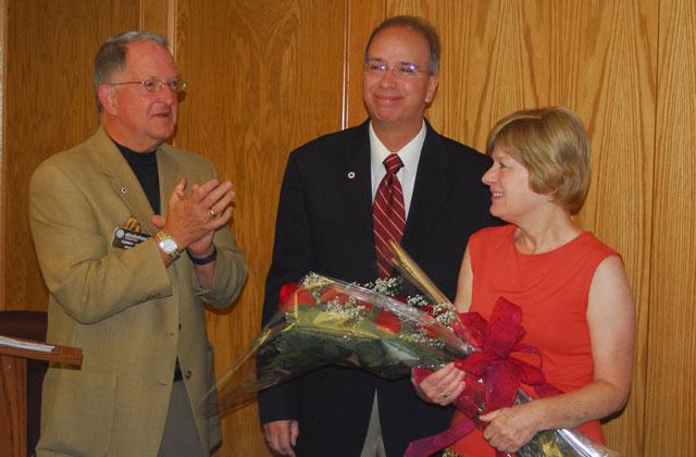 Dr. Jay Conner, chair of the Campbellsville University Board of Trustees, applauds Debbie and Mike Carter, first lady and president of Campbellsville University, who were honored for their 10-year tenure at CU at the Board of Trustees meeting Aug. 11. The "Dr. Michael and Debra Carter Endowed Scholarship Fund" was established in their honor. (Campbellsville University Photo by Joan C. McKinney)