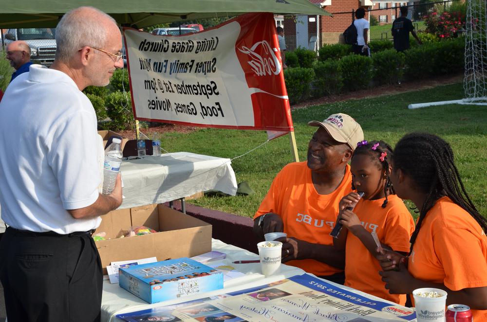 Dr. John Hurtgen (right) shares some memories with Mike Caldwell, director of Pleasant Union Baptist Church, and his daughters, Laneysa and Lavonya. (Campbellsville University photo by Drew Tucker)