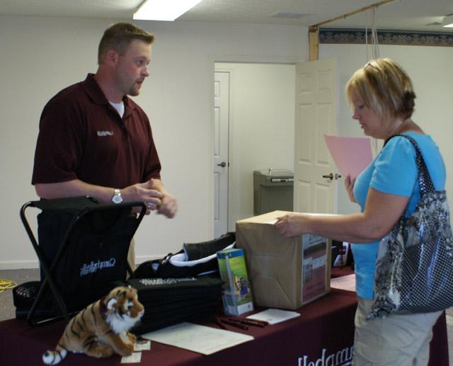 Vicky Fischel picked up information for her daughter, a student at On Fire Christian Academy from Campbellsville University admissions counselor John Ellis. (Photo Courtesty of Linda Ireland, LaRue County Herald News) 