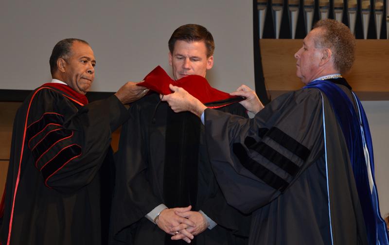 The Rev. Joel Carwile, center, receives his honorary doctorate of divinity hood from Dr. Frank Cheatham, left, senior vice president for academic affairs, and Dr. Joseph Owens, chair of the CU Board of Trustees. (Campbellsville University Photo by Joan C. McKinney)