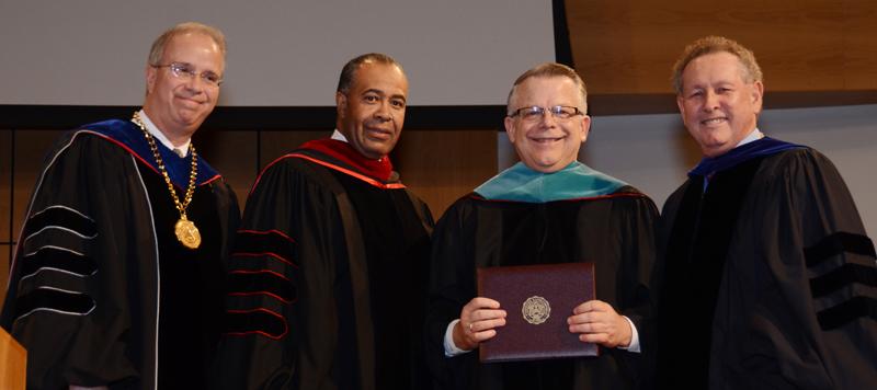 The Rev. John Chowning, second from left, receives an honorary doctorate of public service from Campbellsville University at the 4 p.m. commencement ceremony Dec. 13. Making the presentation, from left, were: Dr. Frank Cheatham, senior vice president for academic affairs; Dr. Joseph Owens, chair of the CU Board of Trustees; and Dr. Michael V. Carter, president. (Campbellsville University Photo by Drew Tucker)