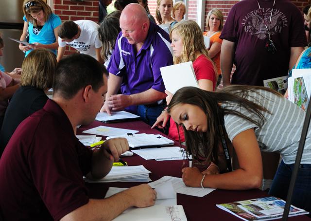 Raven Burress, 465 Pepper Road, Campbellsville, signs up at LINC at Campbellsville University with help from Scott Necesssary, director of dual credit/assistant to the vice president for admissions. (Campbellsville University Photo by Ellie McKinley)