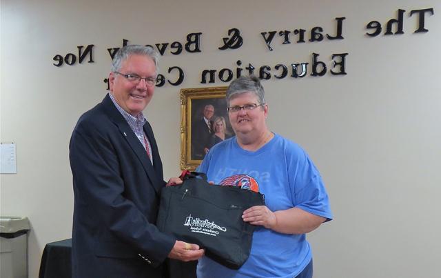 Dr. H. Keith Spears, right, presents a CU Somerset bag and supplies to Karen Smith. 