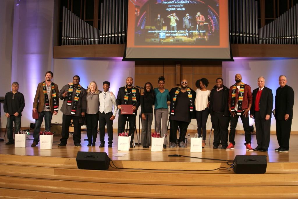 Linkin' Bridge was honored with the CU Kente Cloth at Campbellsville University after the concert. In the photo from left are:  Dr. Keith Spears, vice president for communications and assistant to the president; Dr. Michael V. Carter, president; Linkin' Bridge member Ekoe Alexanda; CU students CJ Calhoun and Maya Spalding; Linkin' Bridge member Montre Davis; CU students Shannon Martin and Natalie Zetrenne; Linkin' Bridge member Shon China Lacy;  CU student Fontez Hill; Dr. Donna Hedgepath, vice president for academic affairs and professor of education; Linkin' Bridge member Big Rome Kimbrough; Tom Mabe, Linkin' Bridge manager, and Jeff Baxter, Linkin' Bridge guitarist. (Campbellsville University Photo by Drew Tucker)   