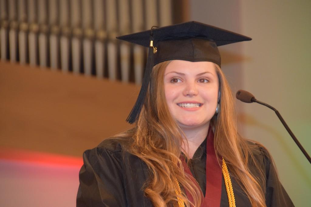 1-As class speaker, Shelby Knuckles accepts the charge set forth by Campbellsville University President Michael V. Carter. (Campbellsville University Photo by Drew Tucker)